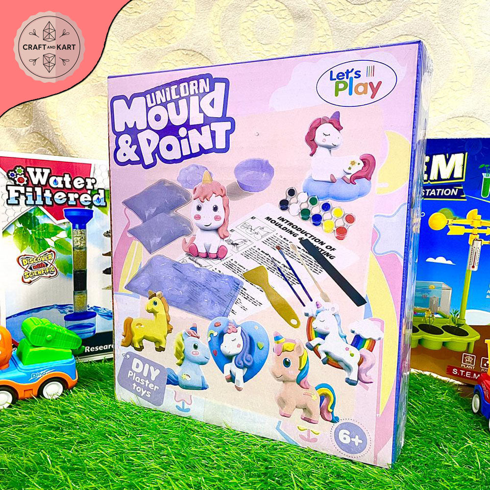 Unicorn-themed mold and paint kit packaging on a grassy background with toys around.