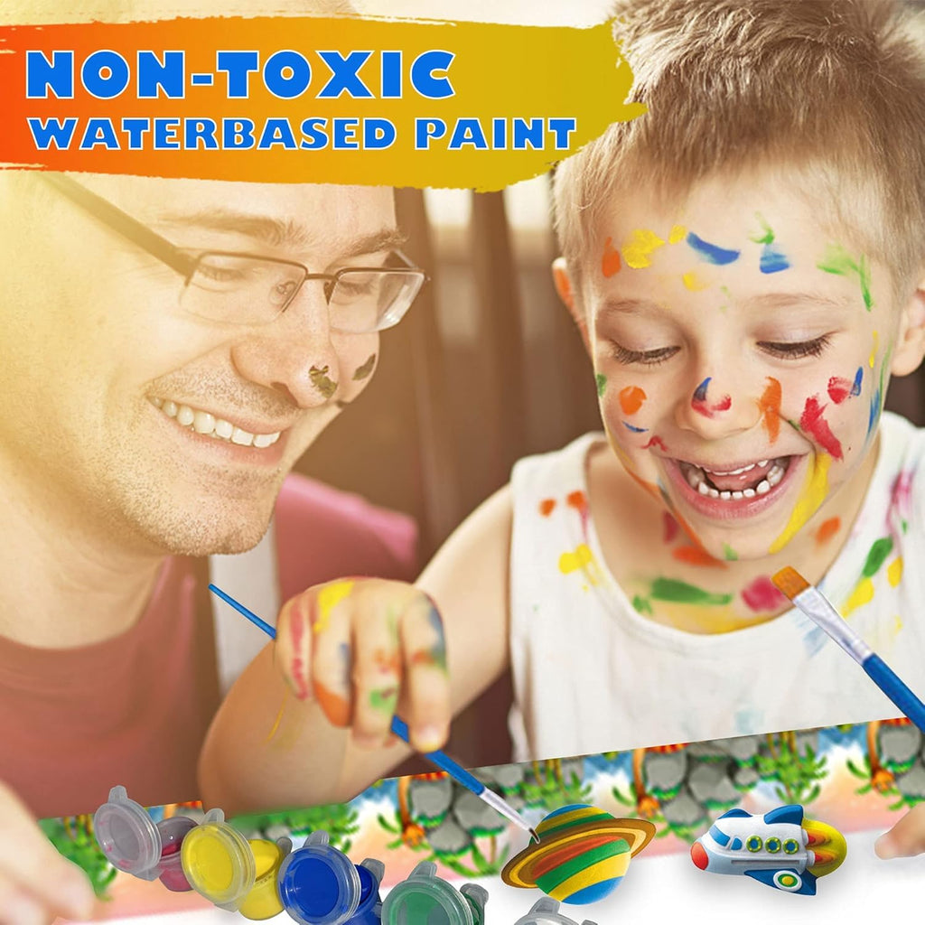 Man and child with paint on faces, surrounded by non-toxic water-based paint supplies.