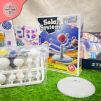 Solar system model kit with packaging on a grass-like surface